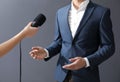 Professional journalist interviewing businessman on background, closeup
