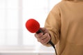 Professional journalist with microphone in room Royalty Free Stock Photo