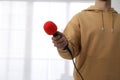 Professional journalist with microphone in room, closeup Royalty Free Stock Photo