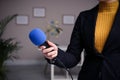 Professional journalist with microphone in room, closeup Royalty Free Stock Photo