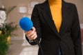 Professional journalist with modern microphone in room Royalty Free Stock Photo