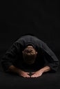 Kendo guru wearing in a traditional japanese kimono is practicing martial art with the shinai bamboo sword against a