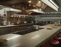 Professional kitchen interior with stainless steel cookware, stovetops, and bar stools. Royalty Free Stock Photo