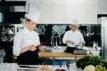 Professional kitchen of a restaurant, a female chef checks the availability of products from an employee. Restaurant warehouse