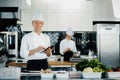 Professional kitchen of a restaurant, a male chef checks the availability of products from an employee. Restaurant warehouse