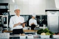 Professional kitchen of a restaurant, a male chef checks the availability of products from an employee. Restaurant warehouse