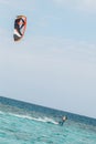 Professional kiter glide the water surface of the ocean at great speed. Back view behind extreme wide shot