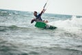 Professional kiter makes the difficult trick on a beautiful background. Royalty Free Stock Photo