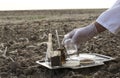 Professional laboratory worker testing soil in the field