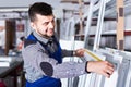 Professional labour with finished PVC profiles and windows at factory Royalty Free Stock Photo