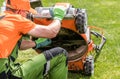 Professional Landscaper Checking on Lawn Mower Blade