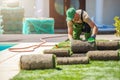 Professional Landscaper Installing New Grass Turfs in a Garden