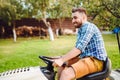 Professional landscaper using tractor at mowing lawn Royalty Free Stock Photo