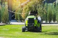 Professional lawn mower with gardener cutting the grass