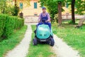 Professional lawn mower worker cutting grass in home garden Royalty Free Stock Photo