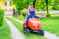 Professional lawn mower worker cutting grass in home garden Royalty Free Stock Photo