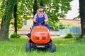 Professional lawn mower worker cutting grass in home garden Royalty Free Stock Photo