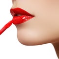 Professional lips make-up. Lipgloss and brush. Lipstick. Beauty girl applying lip gloss. lips. Beauty red lip makeup detail Royalty Free Stock Photo