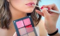 Professional lips make-up. Makeup professional artist applying lip gloss Royalty Free Stock Photo