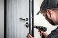 Locksmith repairing entrance door lock Royalty Free Stock Photo