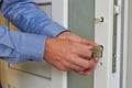 installing a lock on a plastic door,a professional locksmith repairs a door in an office, door repair Royalty Free Stock Photo