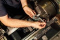 Professional machinist : man operating lathe grinding machine Royalty Free Stock Photo