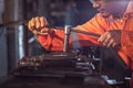 Professional machinist : Worker handles metal at lathe operating lathe grinding machine in uniform with safety - metalworking