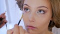 Professional make-up artist applying eyeliner around the entire eye of model Royalty Free Stock Photo