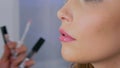 Professional make-up artist applying lip gloss Royalty Free Stock Photo