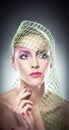 Professional make up - beautiful female art portrait with beautiful eyes. Elegance. Genuine natural woman with veil in studio