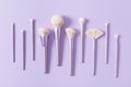 Professional make up tools brushes in a row on a pastel violet background. Set of glamour make up brushes. Magazines, social media Royalty Free Stock Photo