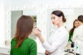 Professional makeup artist applies powder Royalty Free Stock Photo