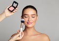 Professional makeup artist apply blush on woman cheeks Royalty Free Stock Photo