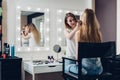 Professional makeup artist working on young girl creating natural look in beauty salon Royalty Free Stock Photo