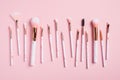 Professional makeup brushes kit on pink background top view Royalty Free Stock Photo
