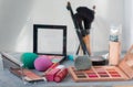 Makeup brush and cosmetics on grey table. Royalty Free Stock Photo