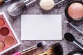 Professional makeup brushes and tools, makeup product set. Blank page notepad and different cosmetic accessories in the holder Royalty Free Stock Photo