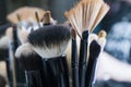 Professional makeup brushes in tube. Dirty makeup tools. Royalty Free Stock Photo