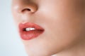 Professional makeup. Lipgloss. Closeup portrait of beautiful girl with colorful red lips and lipstick. Caucasian young woman model Royalty Free Stock Photo