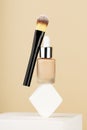 Professional makeup products levitate and balance on white sponge on stand. Bottle foundation liquid bb cream, accessory Royalty Free Stock Photo