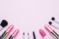 Professional makeup tools. Brushes lipstick blush eye shadow on a pink pastel background with copy space. Flat lay Royalty Free Stock Photo