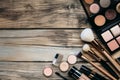 Professional makeup tools. Makeup products on wooden background. Royalty Free Stock Photo