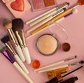 Makeup tools brushes, powder, eyeshadow, glitter, lipstick, mascara on a pink background Royalty Free Stock Photo