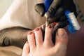 Pedicure removing old coating. Chiropody