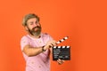 Professional male actor ready for shooting film. prepares for new scene. producer holding movie clapperboard. action Royalty Free Stock Photo