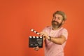 Professional male actor ready for shooting film. prepares for new scene. producer holding movie clapperboard. action Royalty Free Stock Photo