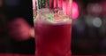 Professional male bartender pouring mixed blue liquor cocktail drink