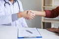 Professional Male doctor in white coat shaking hand with female patient after successful recommend treatment methods, Medicine and Royalty Free Stock Photo