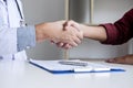 Professional Male doctor in white coat shaking hand with female patient after successful recommend treatment methods, Medicine and Royalty Free Stock Photo