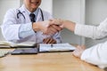 Professional Male doctor in white coat shaking hand with female patient after successful recommend treatment methods, Medicine and Royalty Free Stock Photo